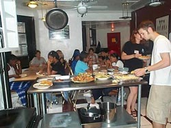 ASB students eating and relaxing in the hostel group kitchen.